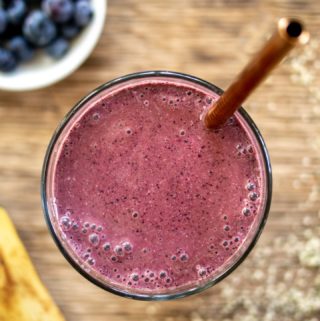 healing smoothie with banana and berries on side