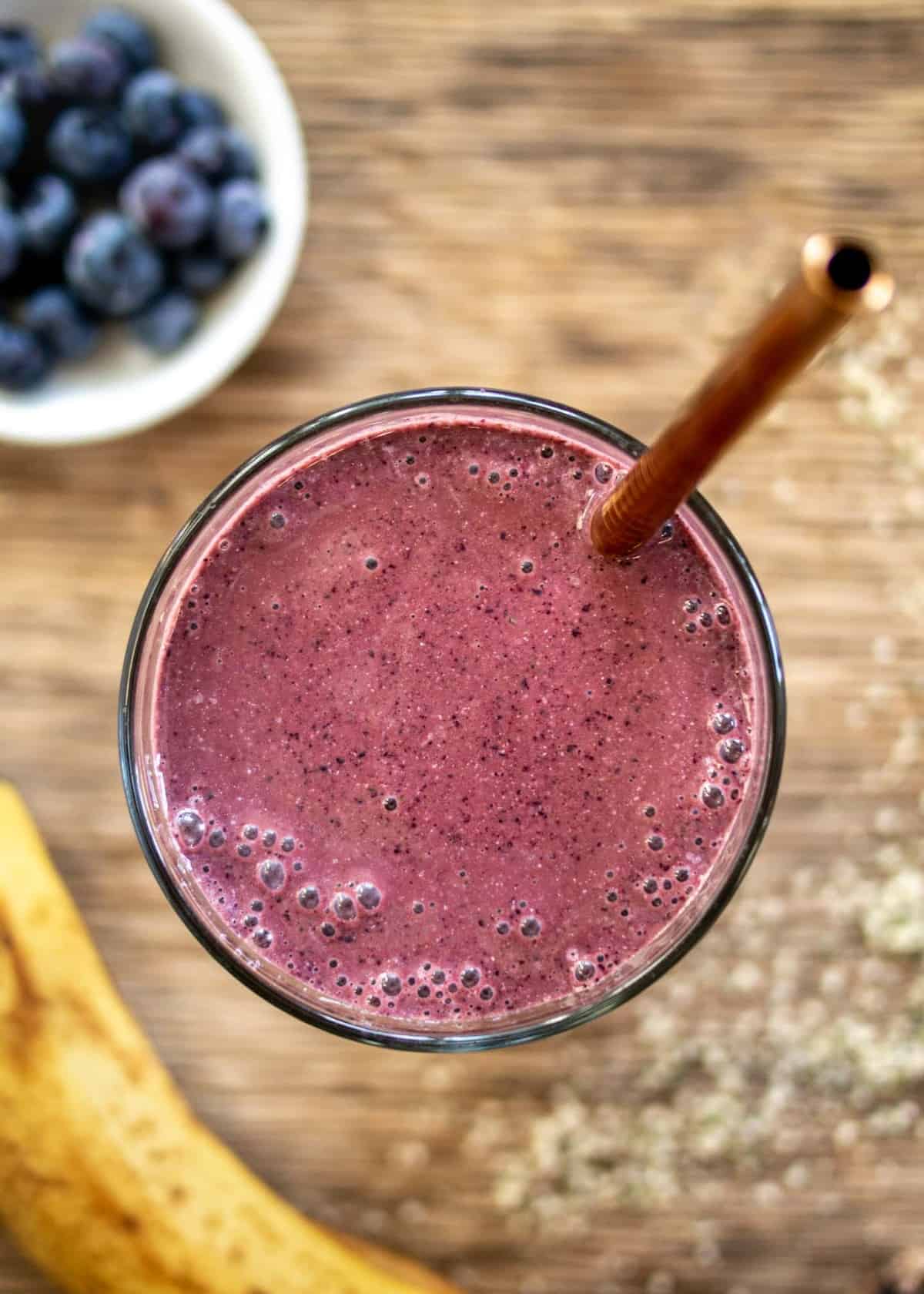 healing smoothie with banana and berries on side