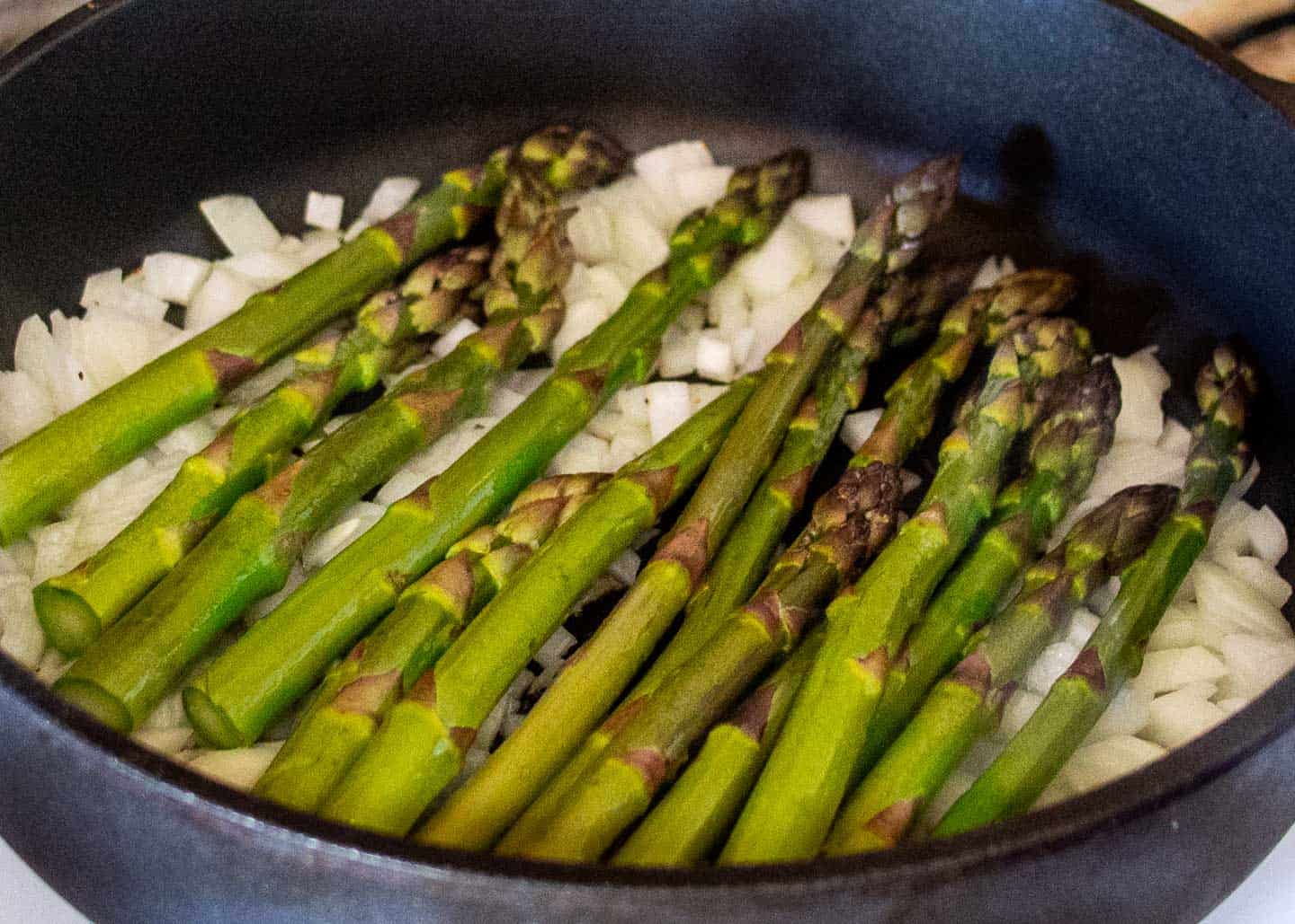 asparagus and onion cooking in frypan