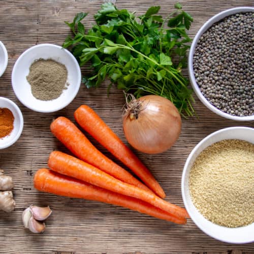 Ingredients for french lentil stew: ginger, garlic, onion, coriander, cayenne, carrots, couscous, lentils and parsley