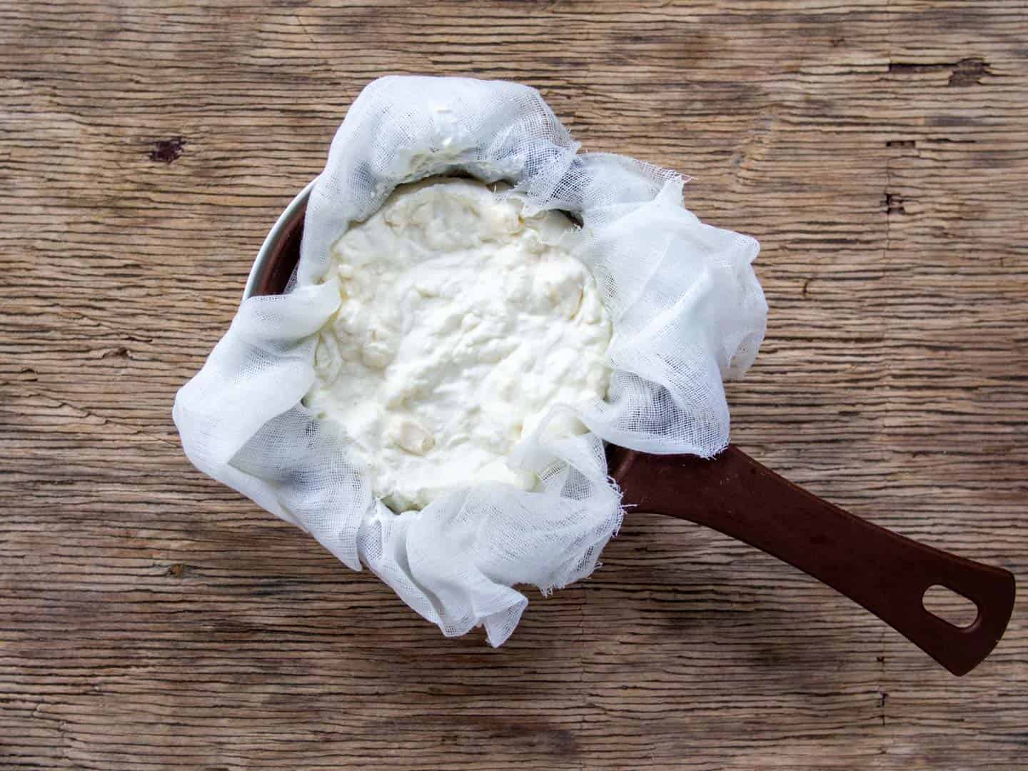 Greek yogurt strained in cheesecloth