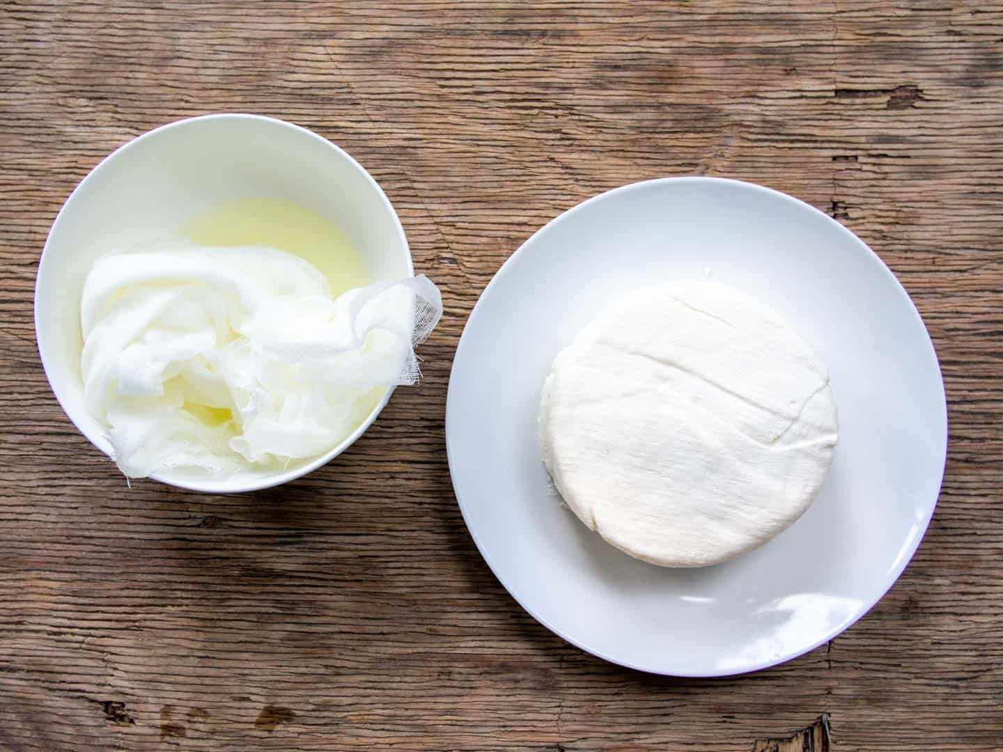 Labneh on white plate with whey on side