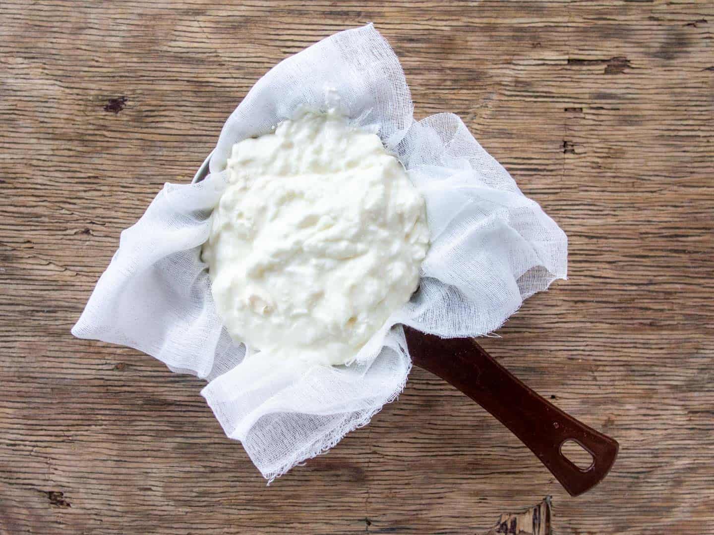 Greek Yogurt on Cheesecloth in Strainer