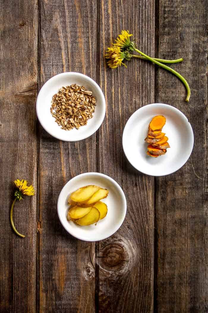 Ingredients for Dandelion Root Latte in white bowls: Dandelion Root, Turmeric Root, Ginger Root