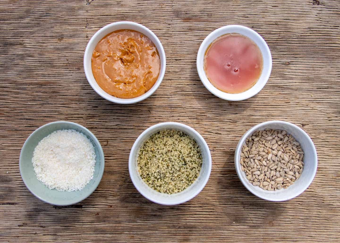 Ingredients for high protein hemp balls in small bowls
