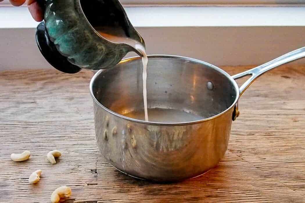 Cashew Milk Poured into Silver Saucepan