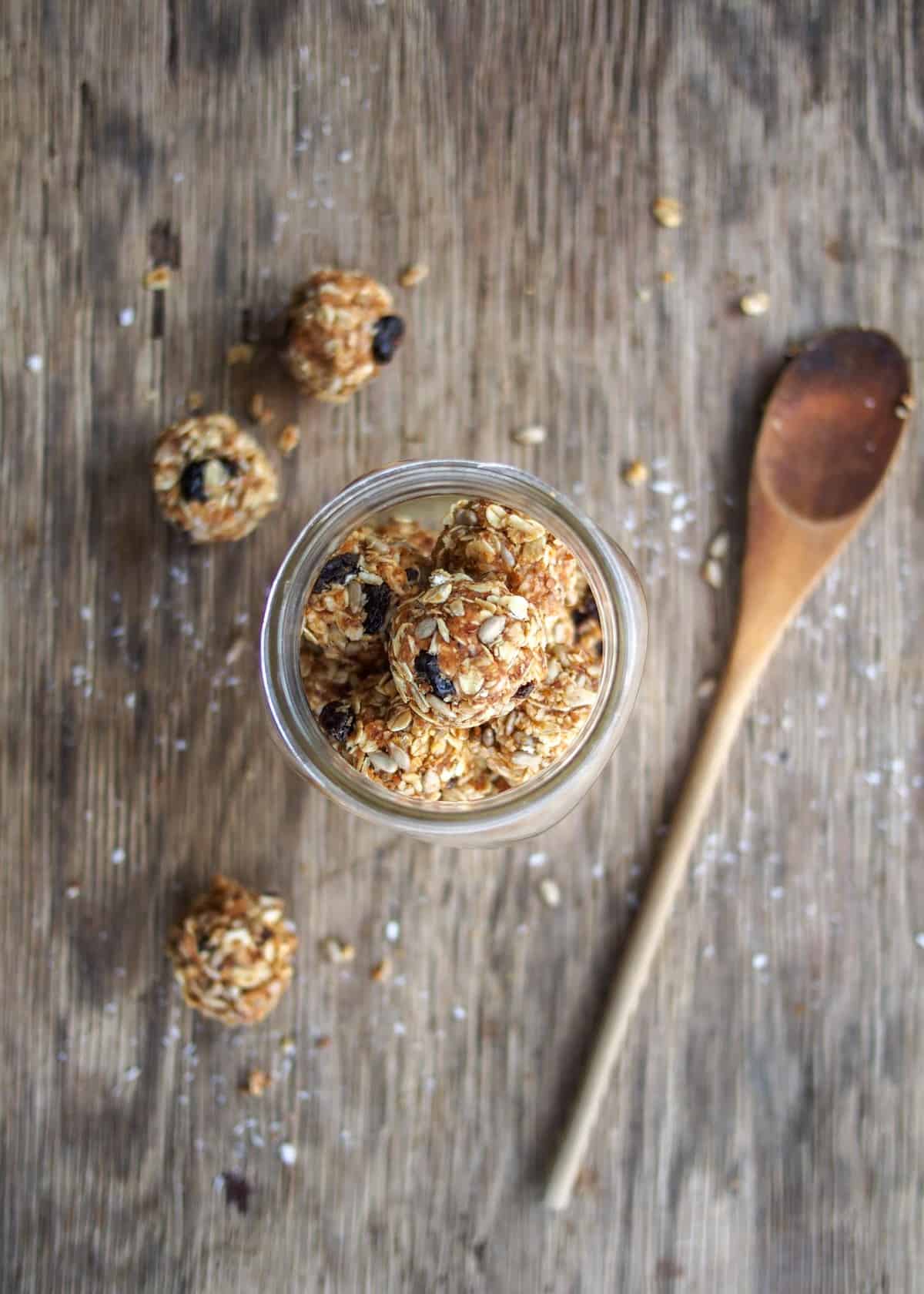 100 calorie peanut butter energy balls with wooden spoon