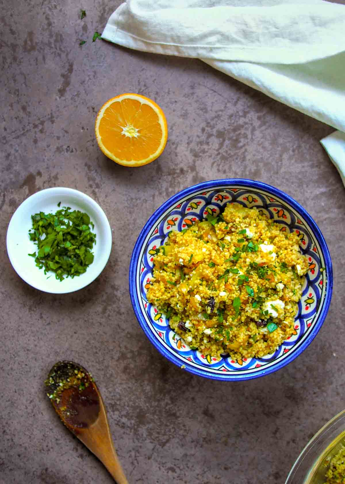 Moroccan Couscous in Blue Bowl with small white bowl of chopped parsley