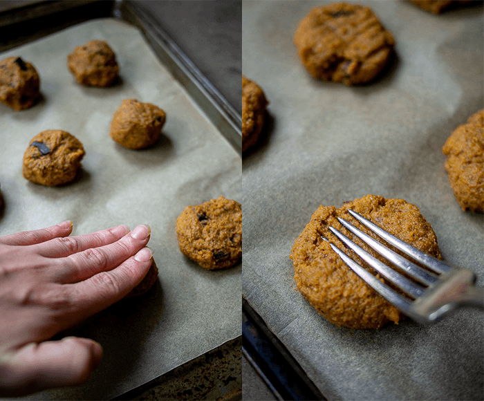 Flattening Soft Pumpkin Cookies with Hand and Indenting with Fork