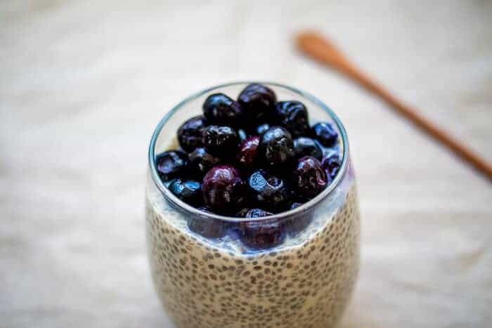 Chia Seed Pudding in Glass Topped with Blueberries for Chia vs Flax