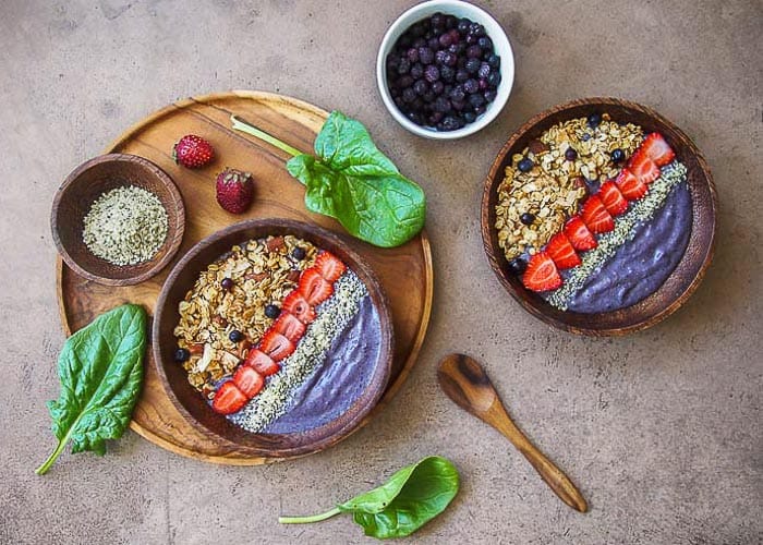 Purple Smoothie Bowl with Spinach Leaves and Bowl of Berries