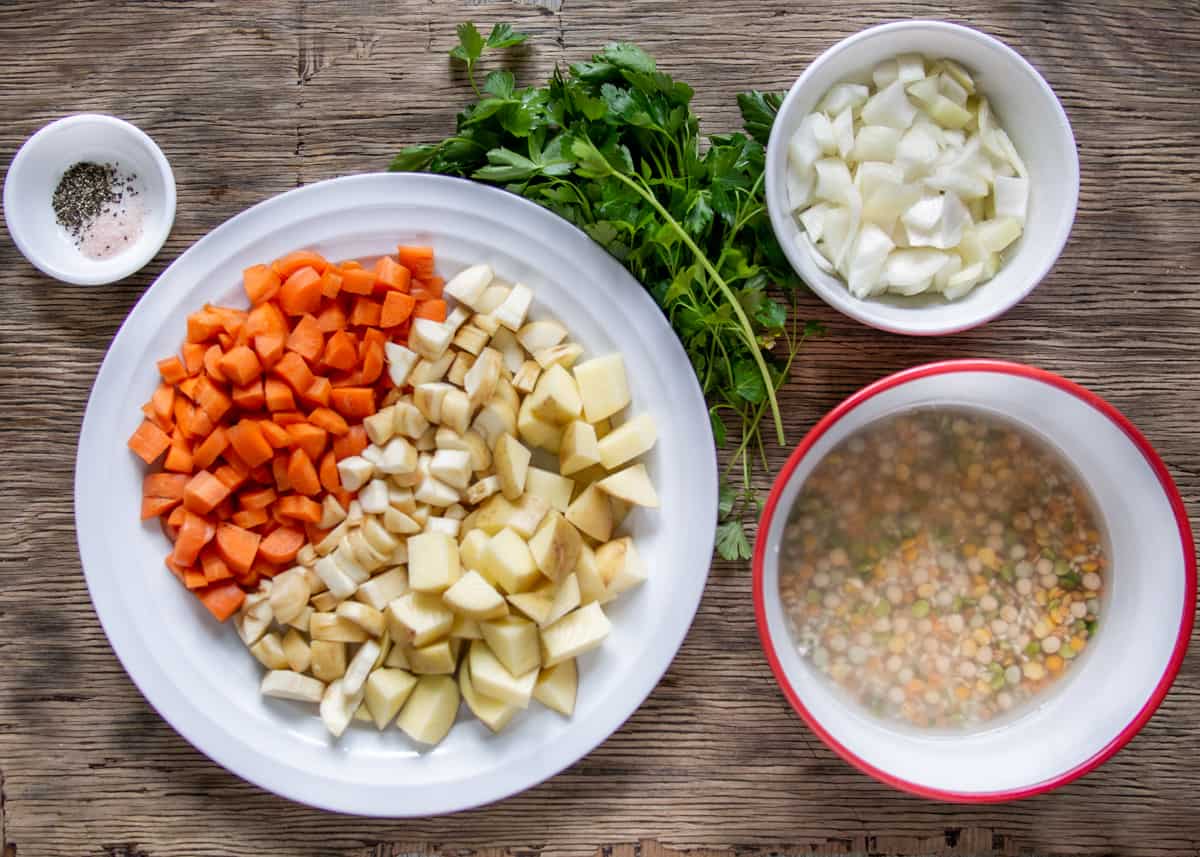 Prepared ingredients for bean soup - chopped onion, carrot, potato, parsnip