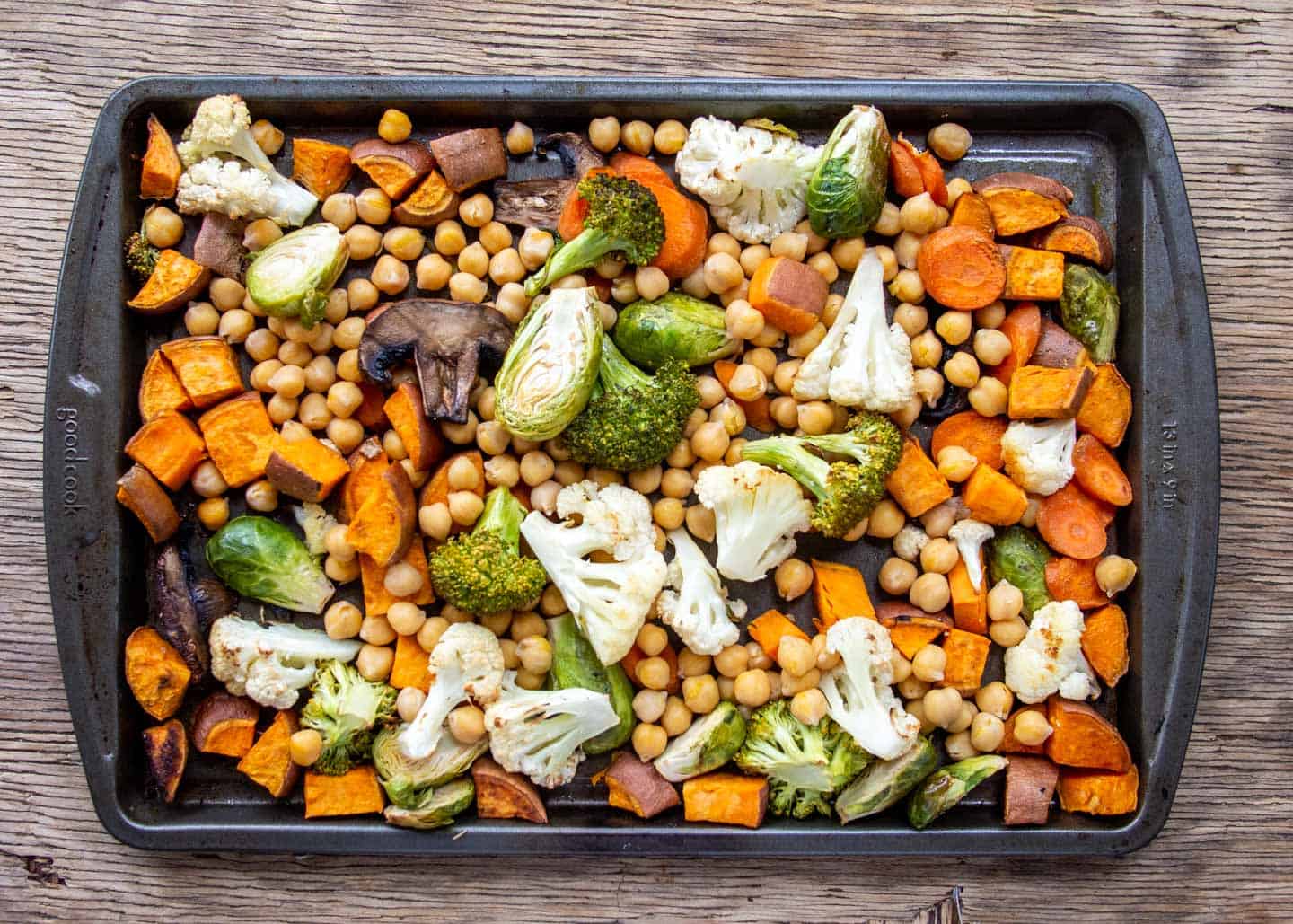 Roasted vegetables and chickpeas on baking tray