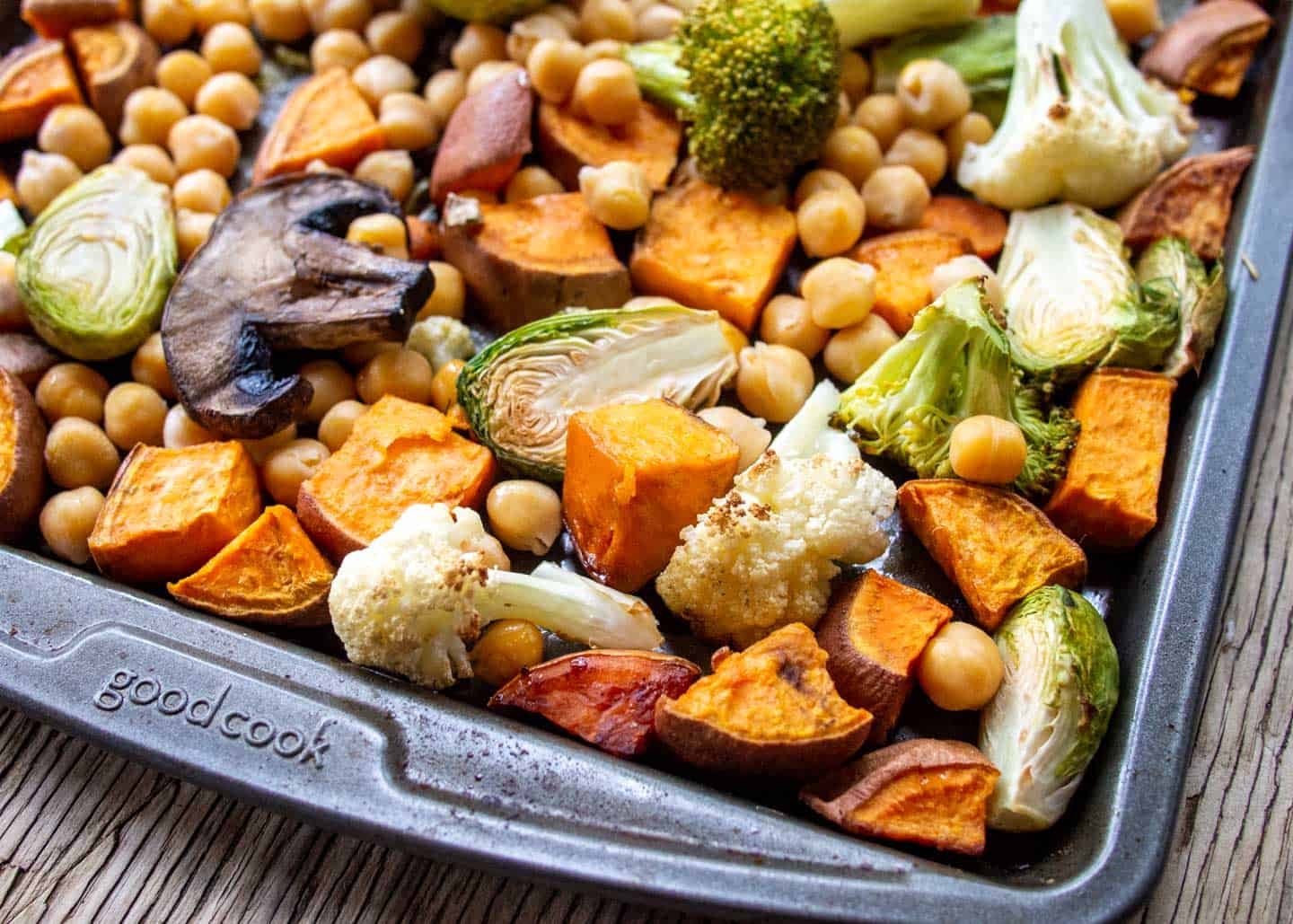 close up of roasted vegetables and chickpeas on baking tray